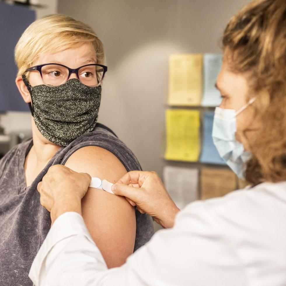 Woman getting a vaccine at a doctor's office
