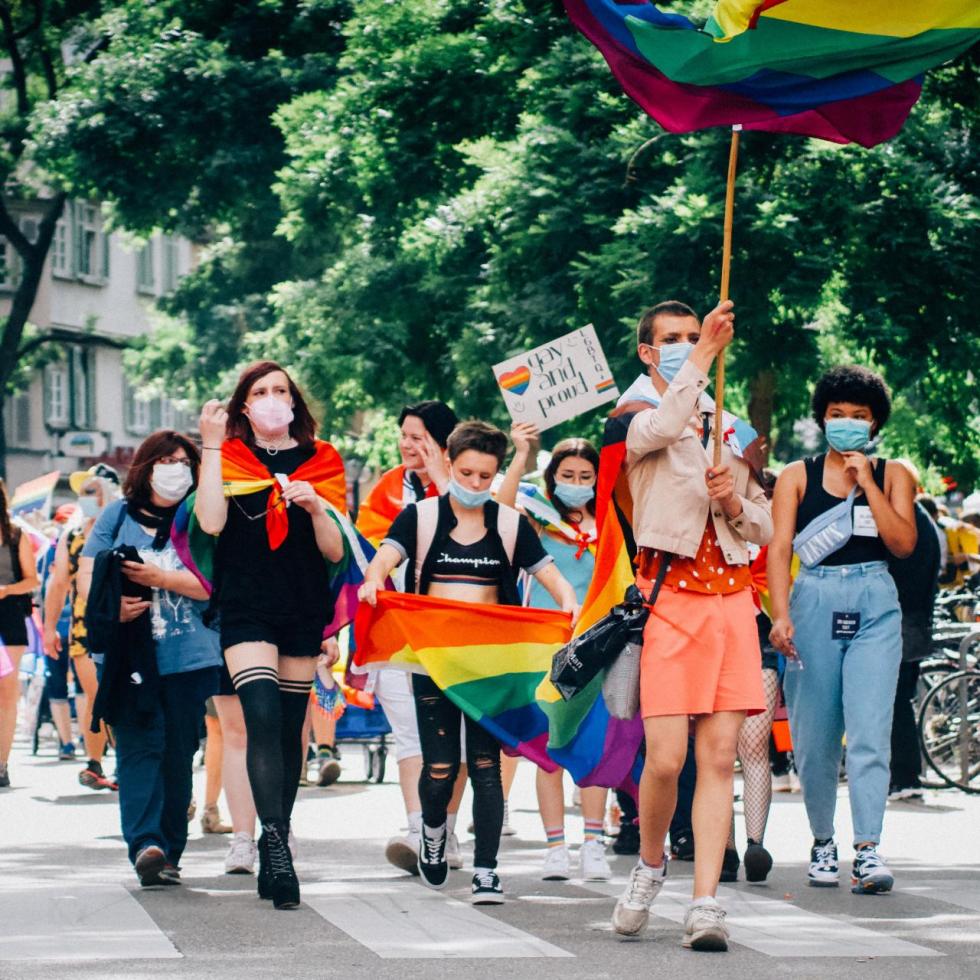 Diverse youth participating in a LGBTQIA+ pride parade