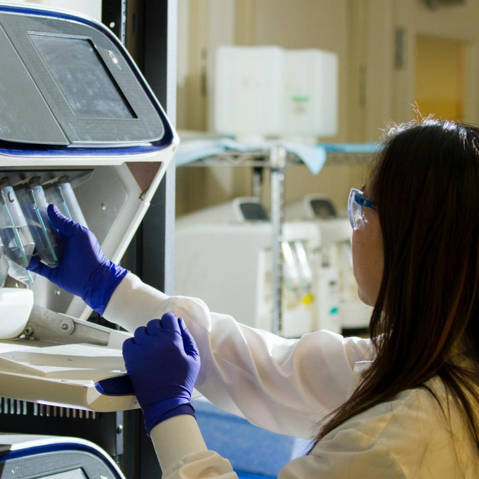 Photo of scientist looking at a microscope