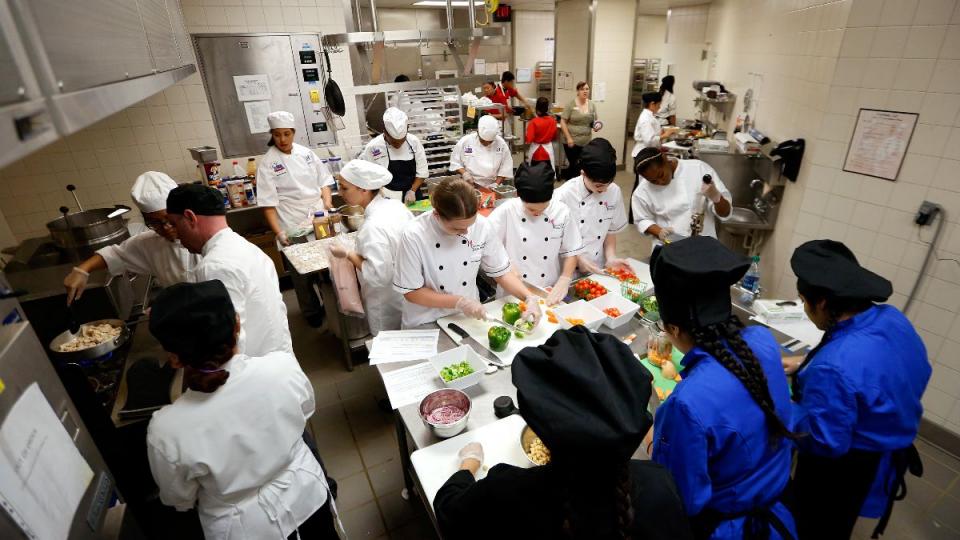 A behind the scenes look at students in the kitchen during a Cooking up Change National Contest