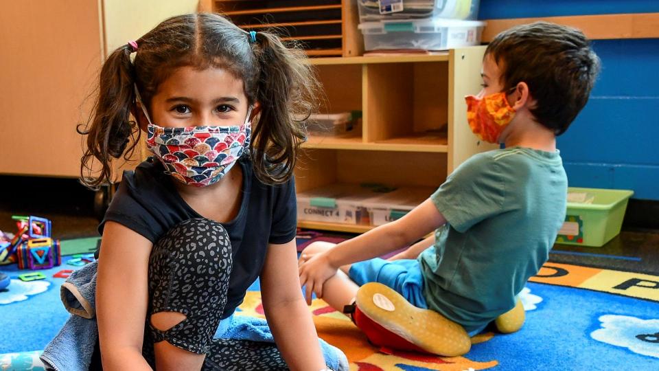 Two students in a community hub wearing masks