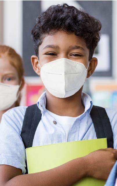 young person with a backpack wearing a face mask