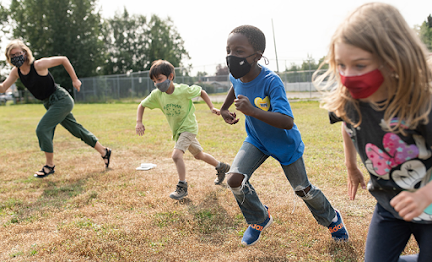 Students outside running with mask