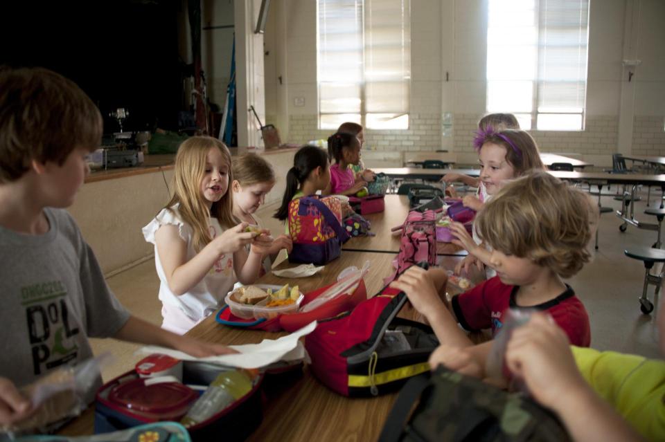 Group of kindergarteners eating in a cafeteria