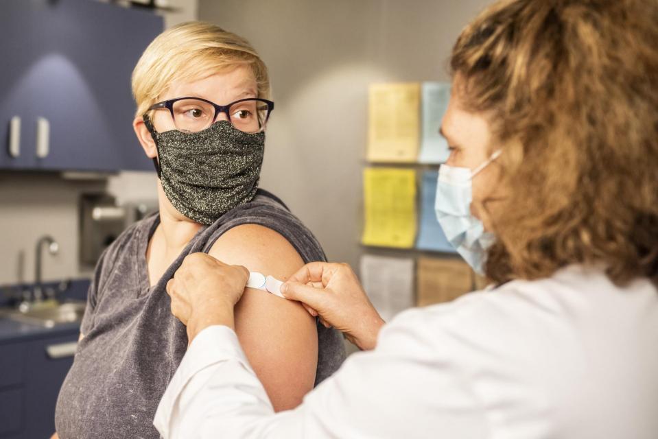 Woman getting a vaccine at a doctor's office