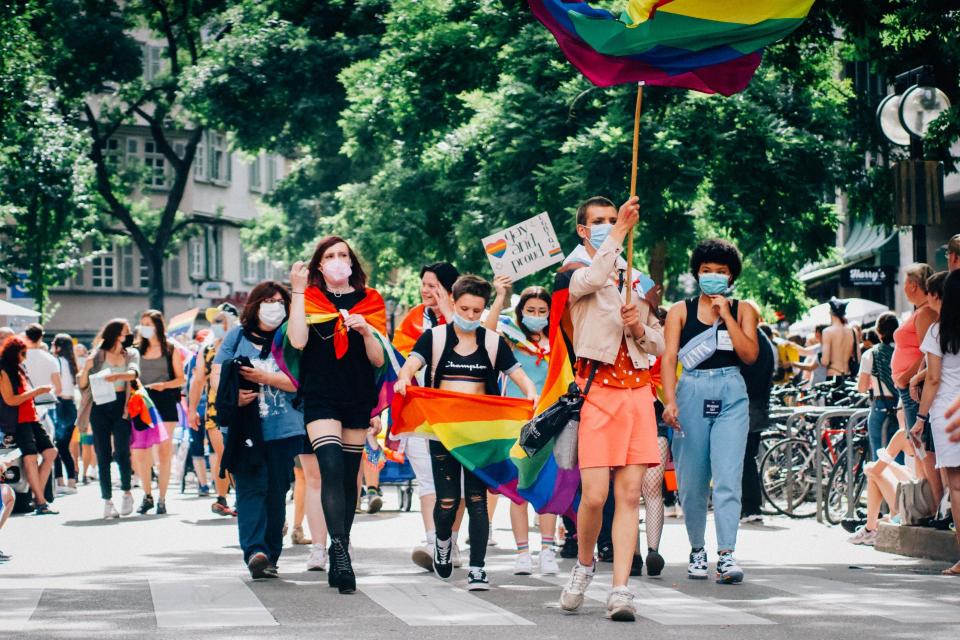Diverse youth participating in a LGBTQIA+ pride parade