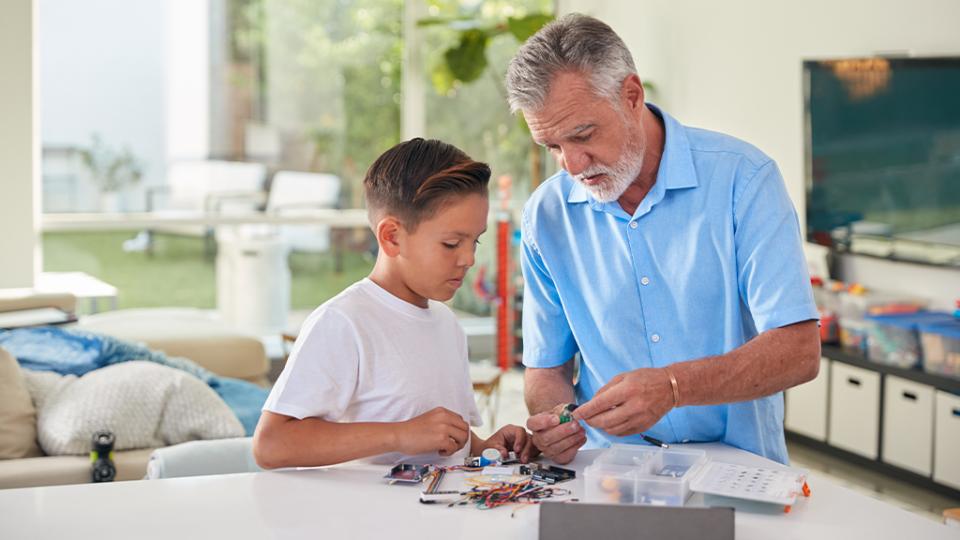 Grandparent and grandson working together on a project