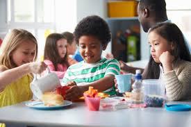 Group of children eating lunch in a cafeteria