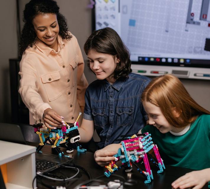 3 Girls working in a techlab making robots