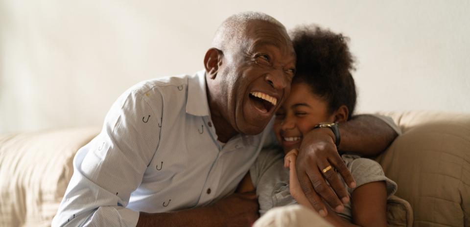 Father and daughter hugging on couch