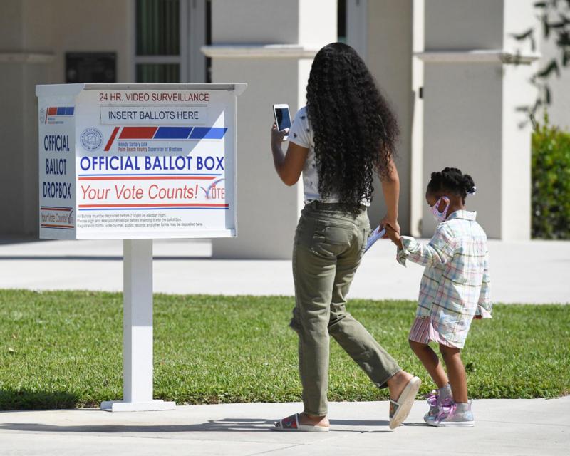 Women and child with election ballot box