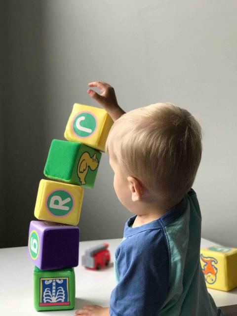 children stacking blocks on top of each other