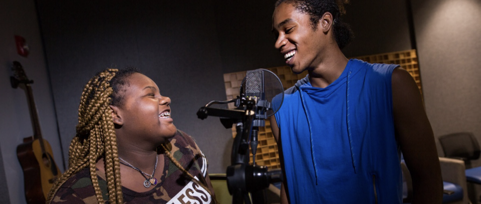Two teenagers laughing and talking