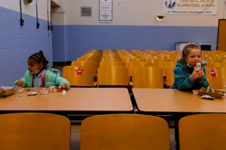 Two students eating breakfast in the cafeteria