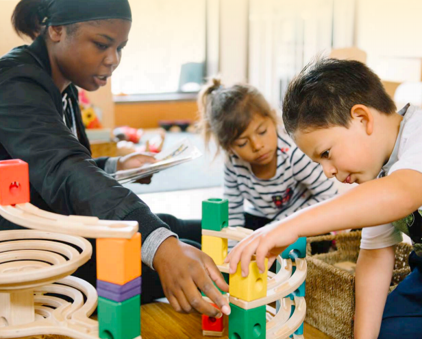 Teacher with two students playing with blocks 