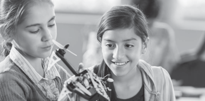 Two girls looking at a microscope