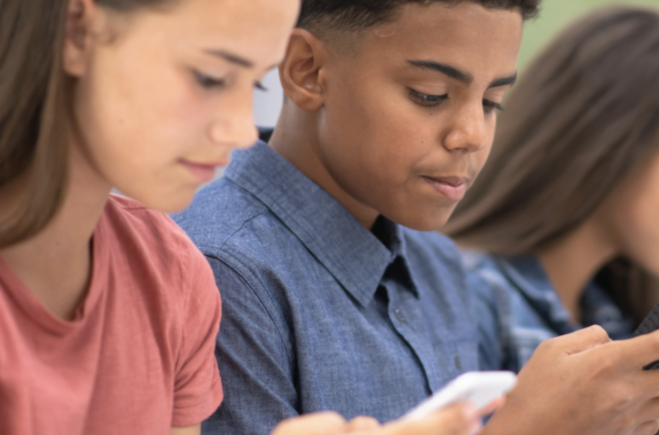 Two youth on their cellphones