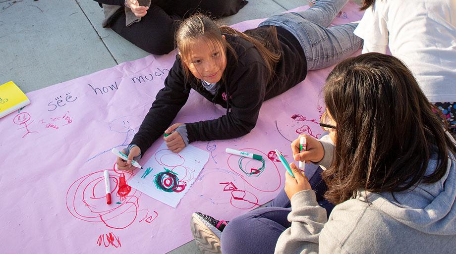 Girls outside drawing