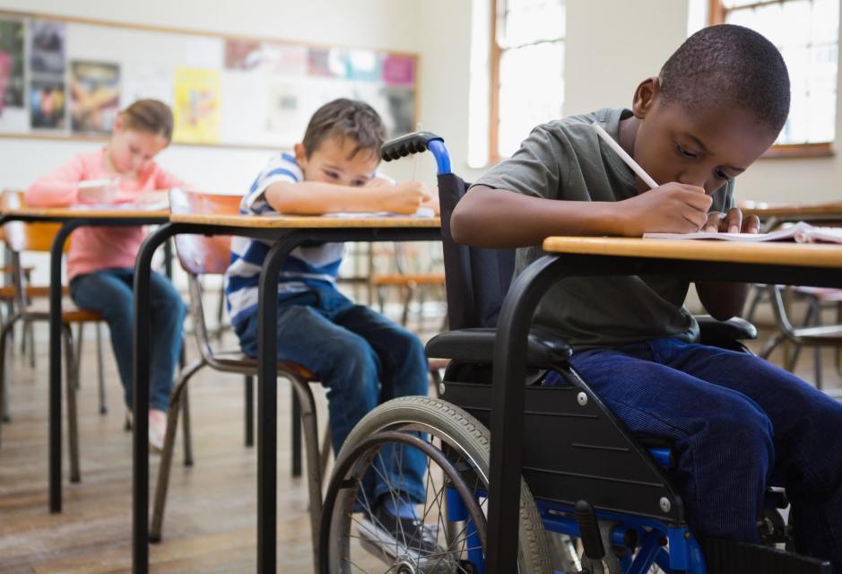 Students writing at Desks 