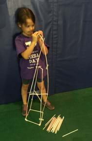A student makes a straw tower within time and material constraints.