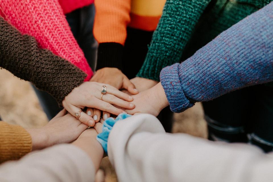 Community of hands on top of each other