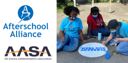 Students outside using chalk