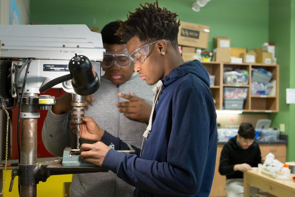 Two students working with a microscope