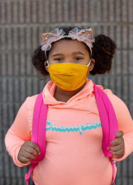A second-grader wearing a face mask, poses for a quick portrait. 
