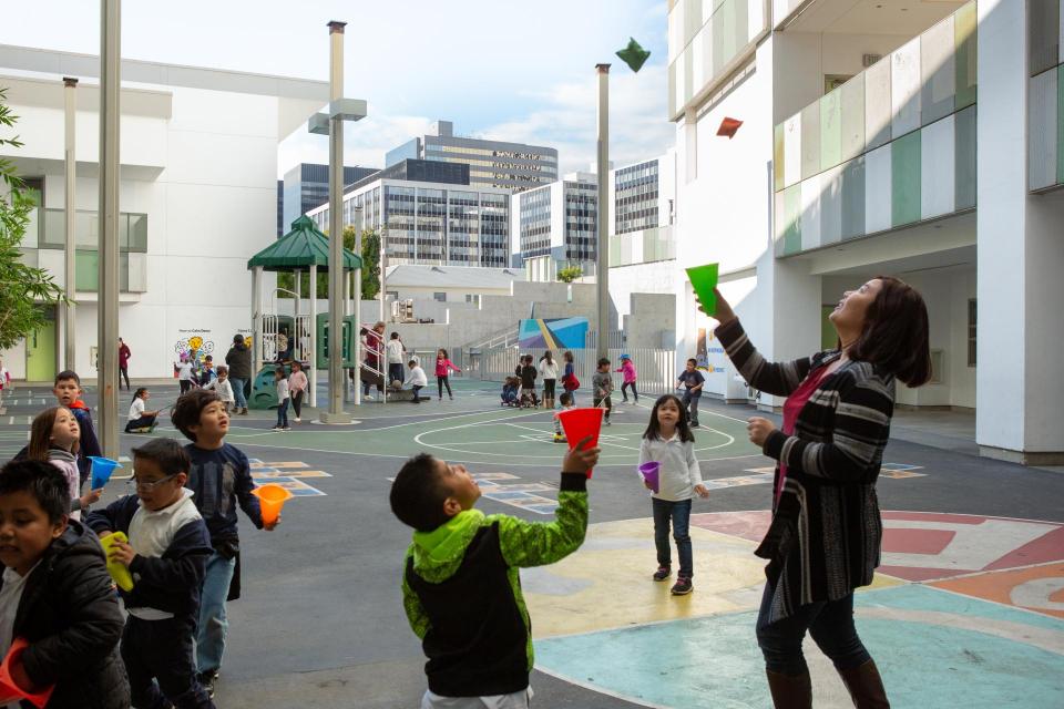 Teacher and students playing on blacktop