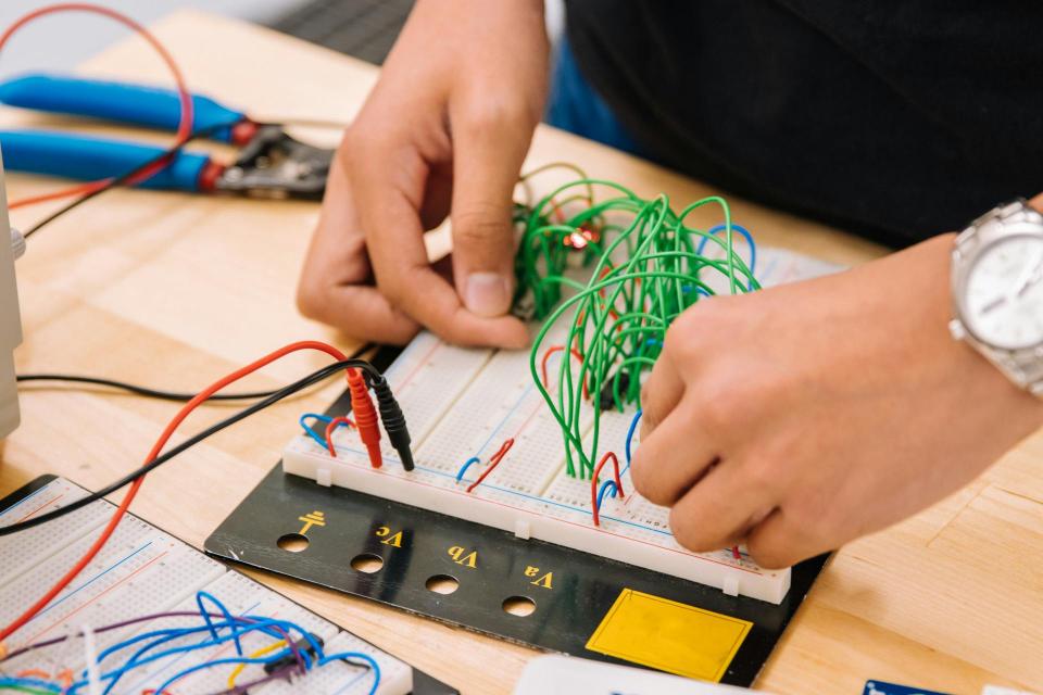 Someone working with wires on a table