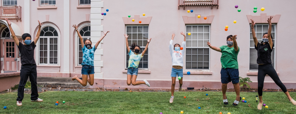 Lights On Afterschool Image- Kids and Adults jumping and throwing confetti