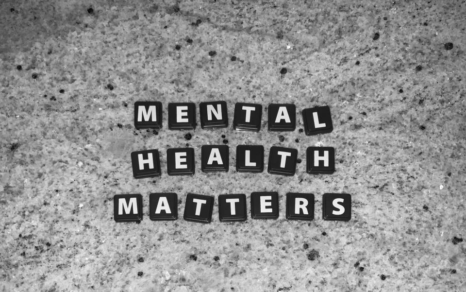 Black Scrabble pieces spelling out "Mental Health Matters"