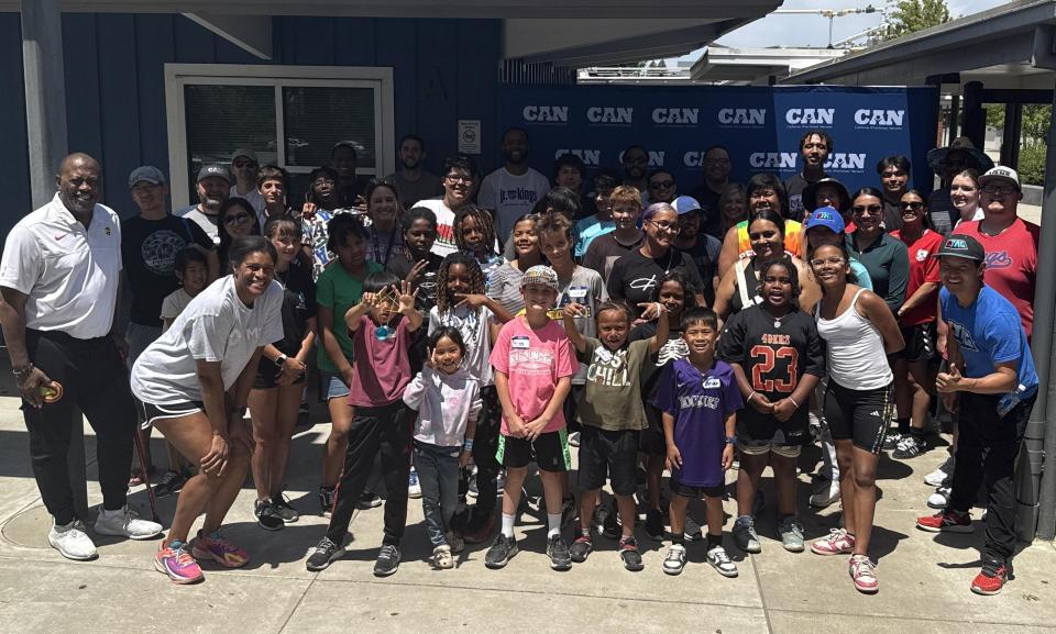 Group photo of students, staff, and community members at a school site