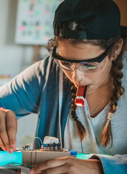 Cover of Afterschool Matters; girl working on science experiment