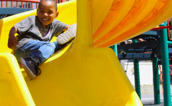 Student coming down slide