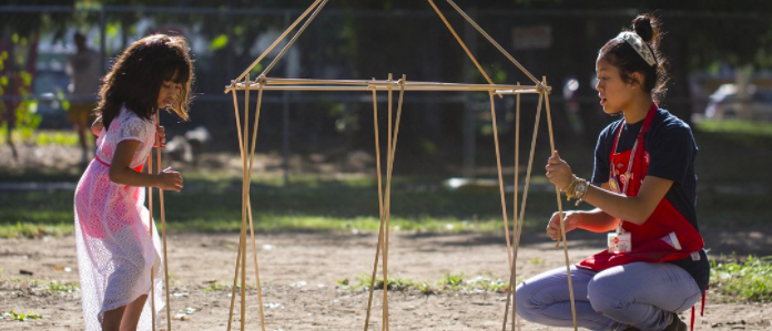 Girl and teacher working on activity outside