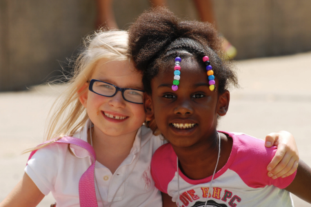 Two girls smiling into the camera