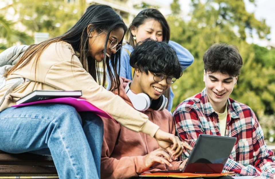 Group of adolescents looking at a computer