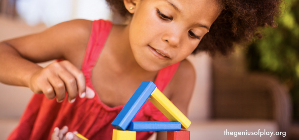 Picture of a girl playing with wooden blocks