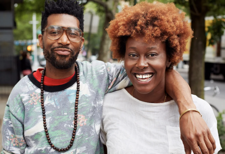 Photo of an African-American man and woman with their arms around each other's shoulders.