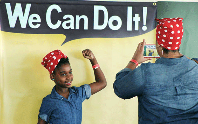 Photo of Black girl dressed as Rosie the Riveter