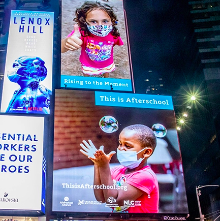 Times Square in New York showing "This is Afterschool" ads. 